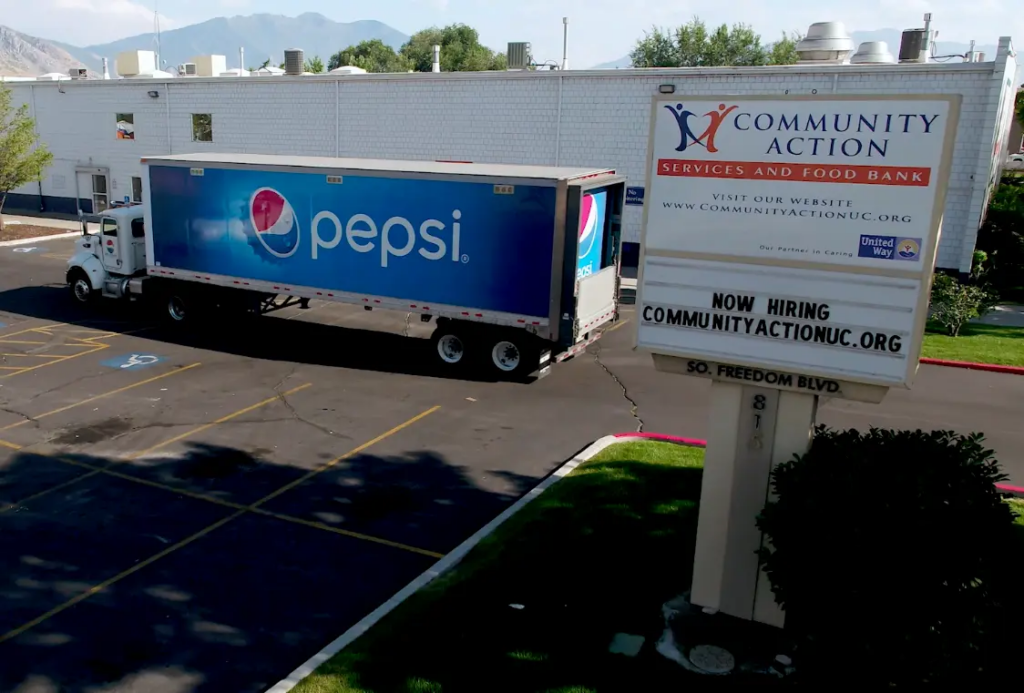 a pepsi-branding semi-truck parked outside of a food bank