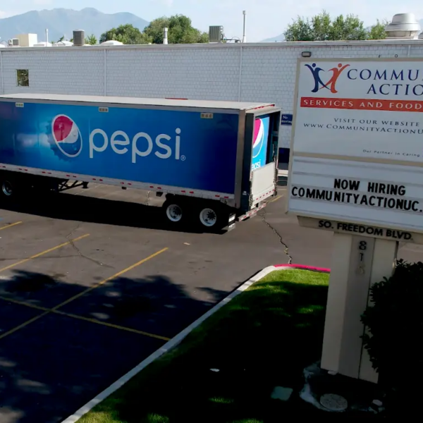 a pepsi-branding semi-truck parked outside of a food bank